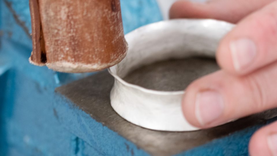 Hammering a anticlastic bangle with a hide mallet