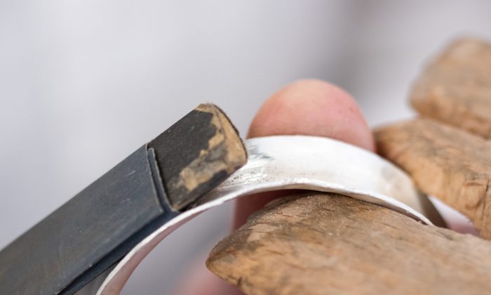 Anticlastic bangle being sanded