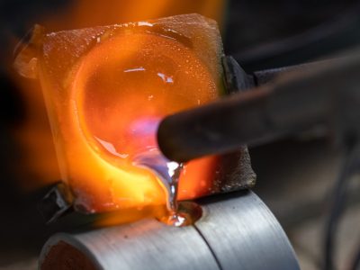Molten silver being poured into a casting flask