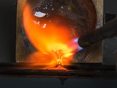 Silver being melted down using a torch